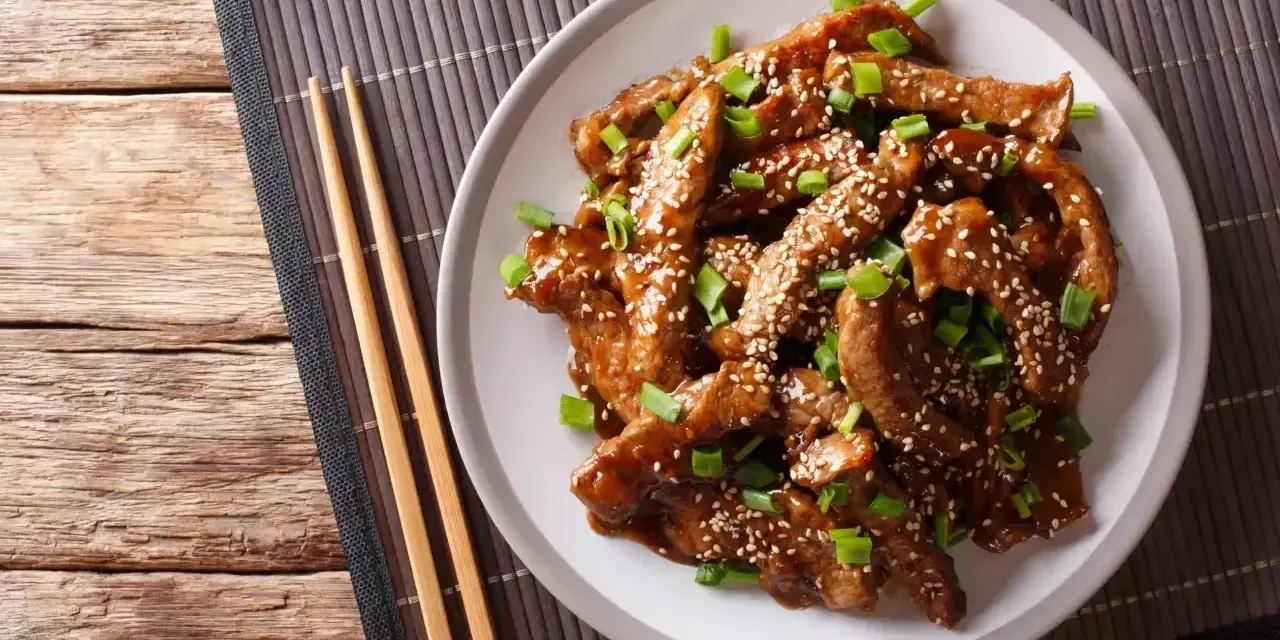 Pyszne mięso w sosie teriyaki, posypane sezamem i szczypiorkiem. Idealne do przygotowania w domu, oto prosty sos teriyaki przepis.